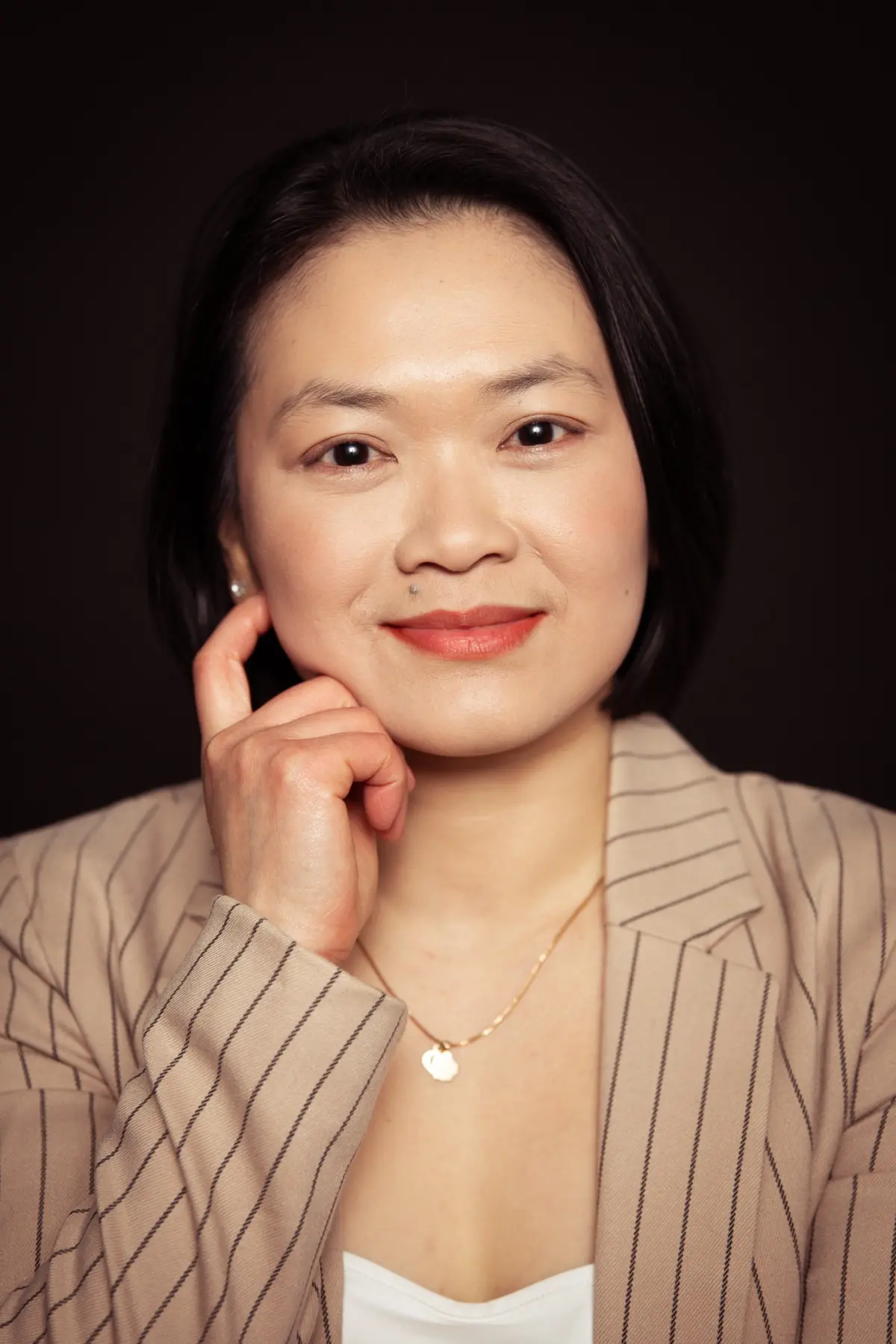 Close-up portrait of Adelynn in a striped blazer