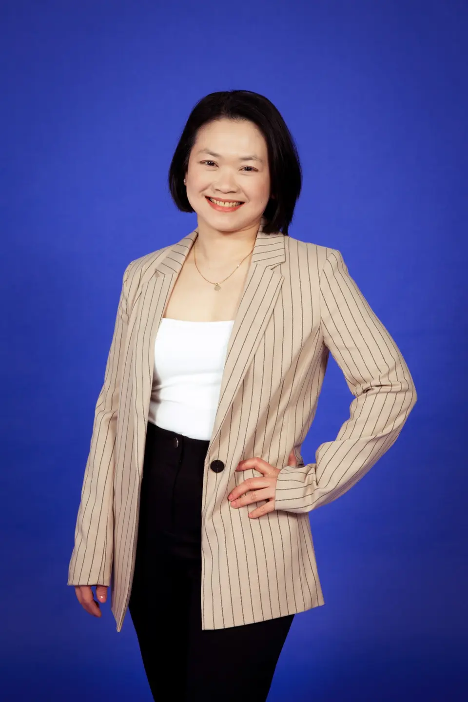 Adelynn Lim in a striped blazer against a blue background