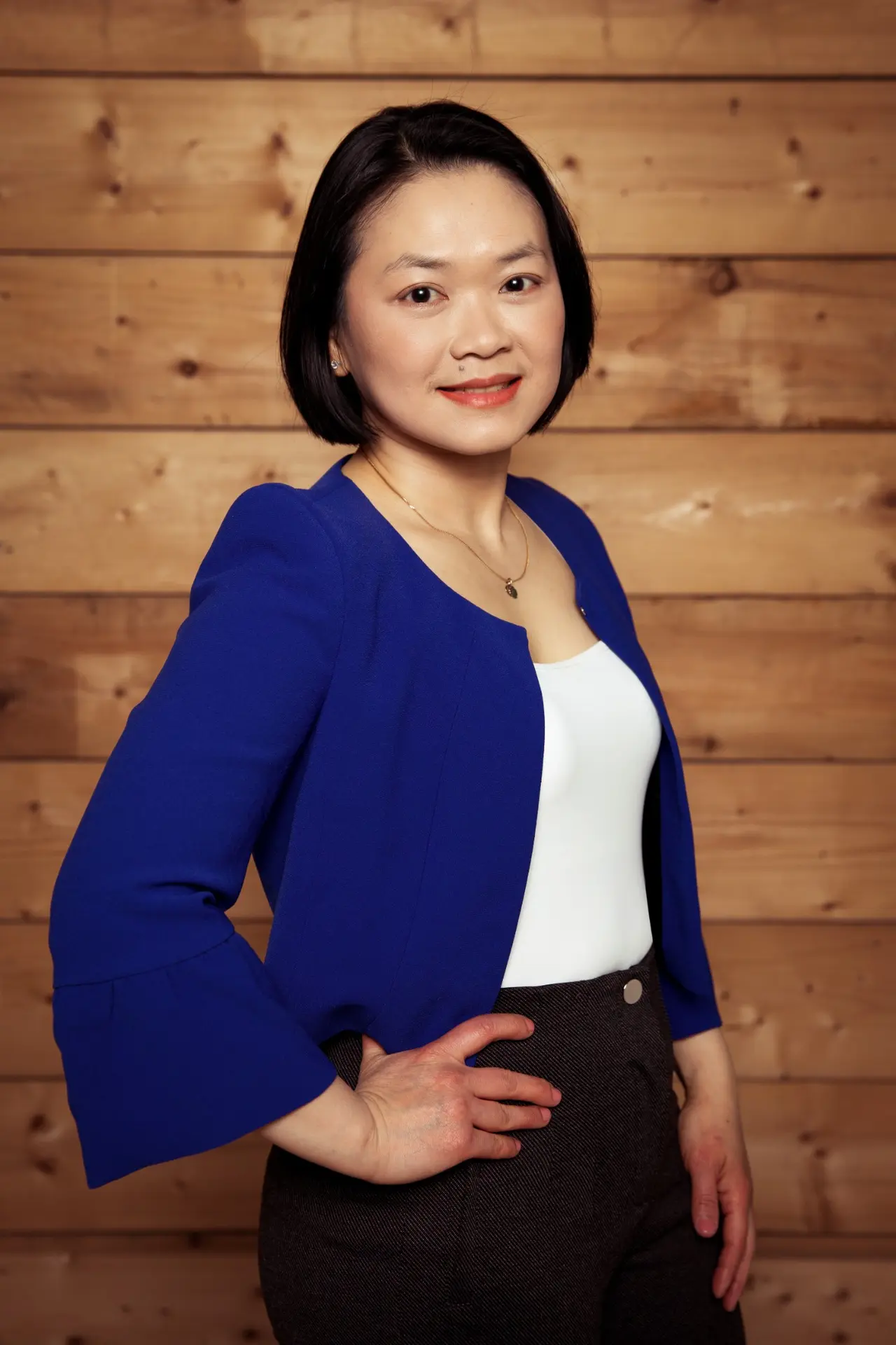 Adelynn Lim in a cobalt blue jacket, certified RTT practitioner and clinical hypnotherapist
